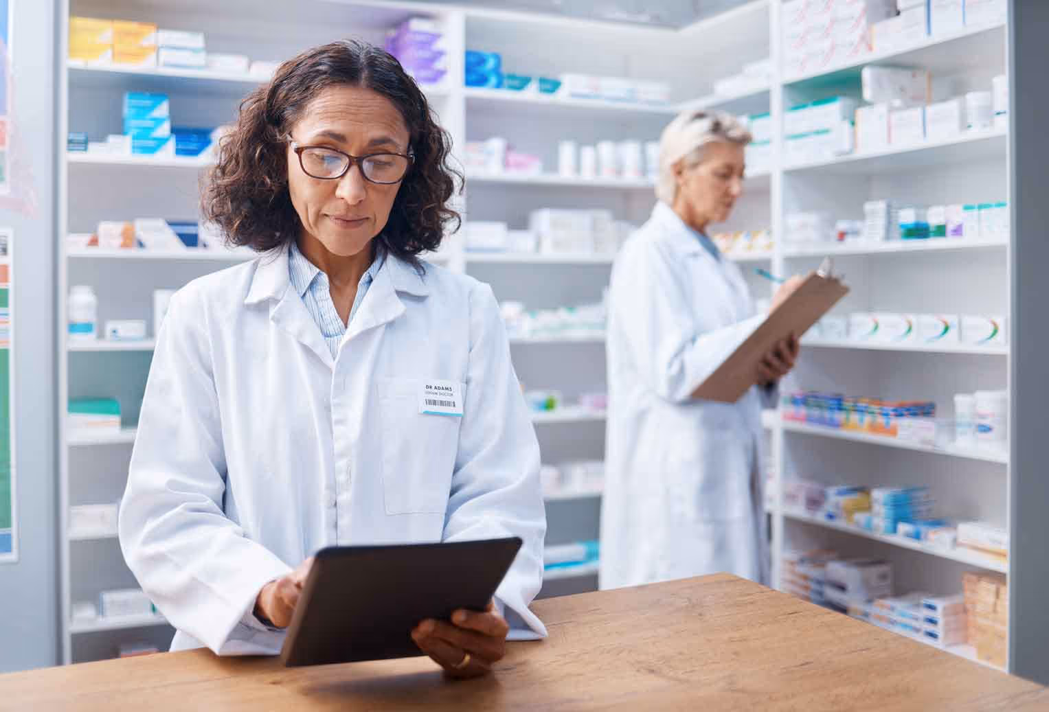pharmacist using tablet to get instructions from a chatbot